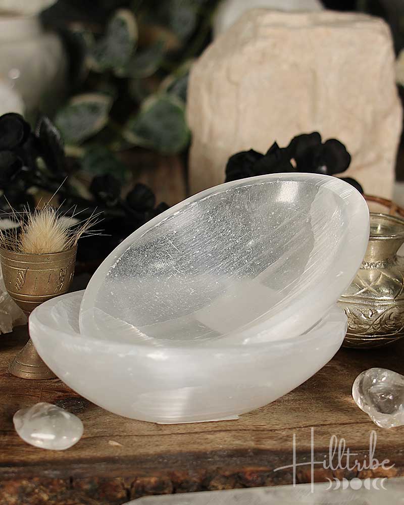 Selenite Crystal bowl on a wooden surface with blurred background