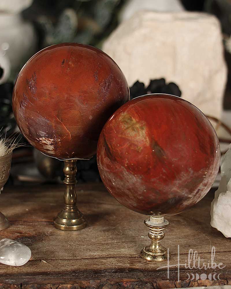 Two Petrified Wood Spheres on stands with a rustic background