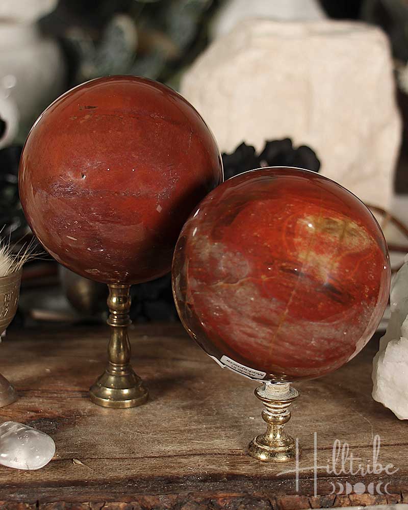 Two Petrified Wood Spheres on stands with a rustic background