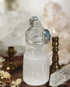 Crystal mug with silver handle on a wooden surface with blurred background