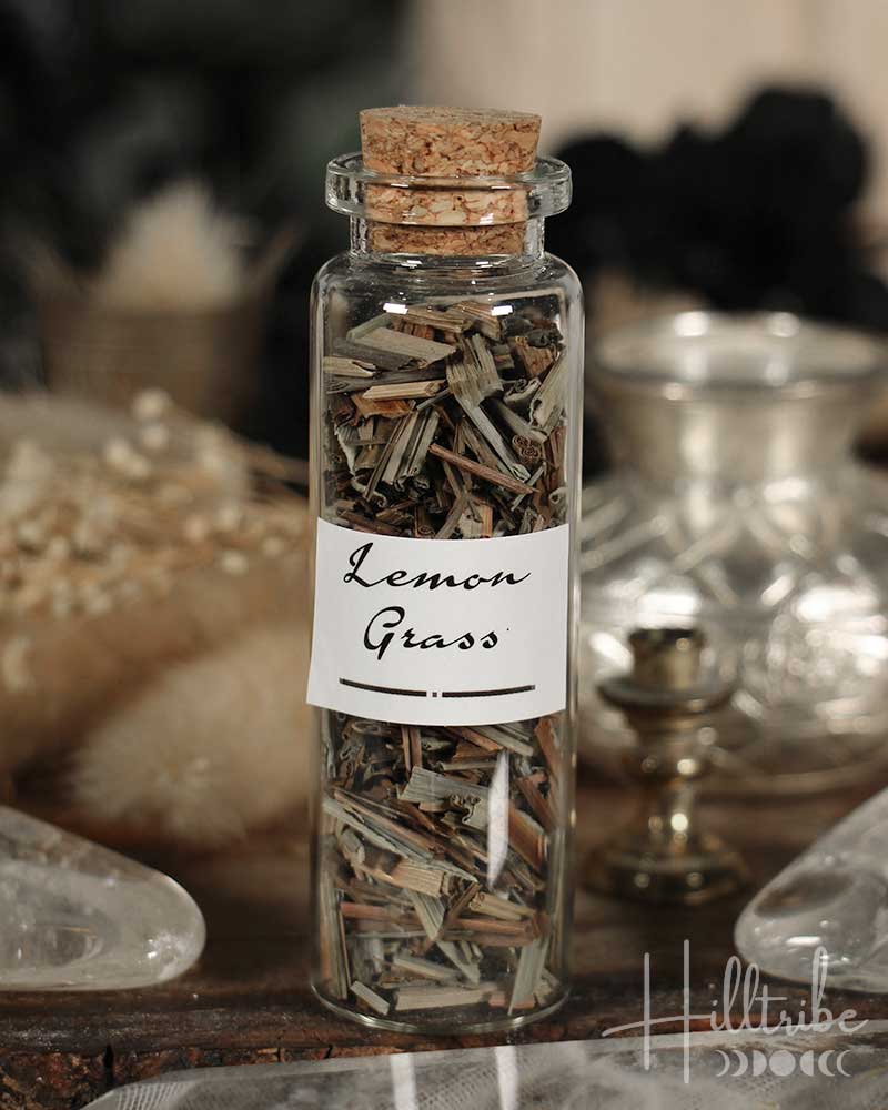 Glass bottle labeled 'Lemon Grass' with cork lid on a wooden surface.