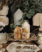 Two Rose Amethyst and Jasper Mini crystal towers on a decorative stand with a blurred background