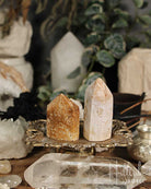 Two Rose Amethyst and Jasper Mini crystal towers on a decorative stand with a blurred background