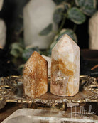 Two Rose Amethyst and Jasper Mini crystal towers on a decorative stand with a blurred background