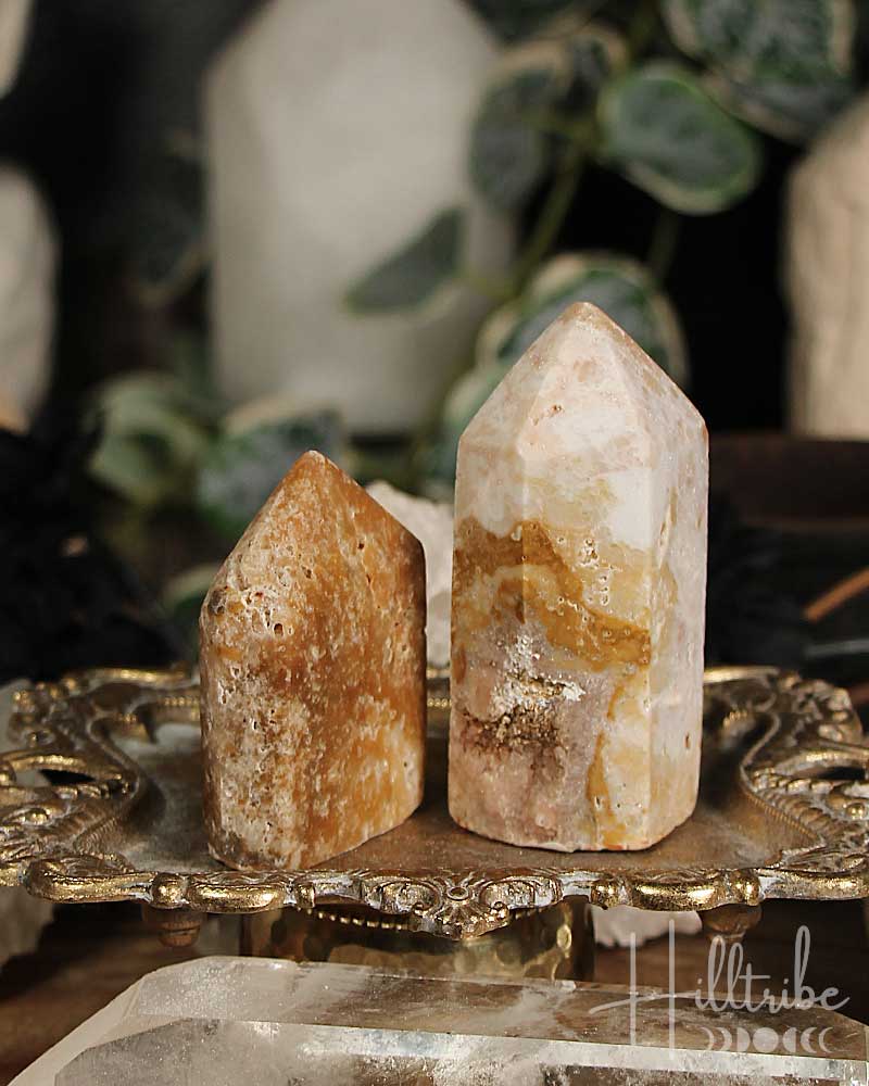 Two Rose Amethyst and Jasper Mini crystal towers on a decorative stand with a blurred background