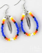 Colorful beaded earrings with feather designs on a white background