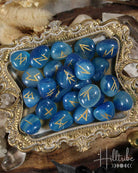 Blue Onyx stones with gold runes on an ornate silver tray, with 'Hilltribe' branding.