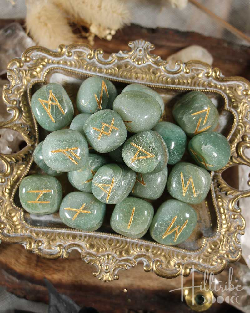 Green Aventurine stones with gold runes on a decorative tray
