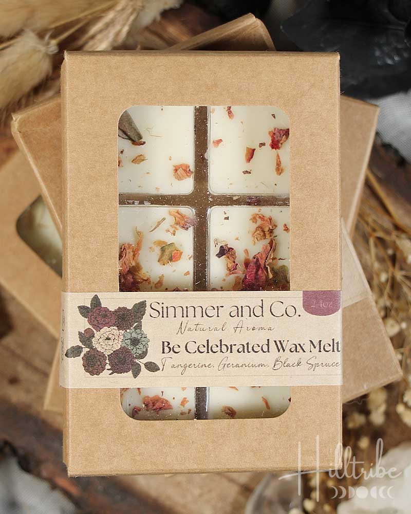 Box of 'Be Celebrated Wax Melt' by Simmer and Co. on a wooden surface with strawberries.