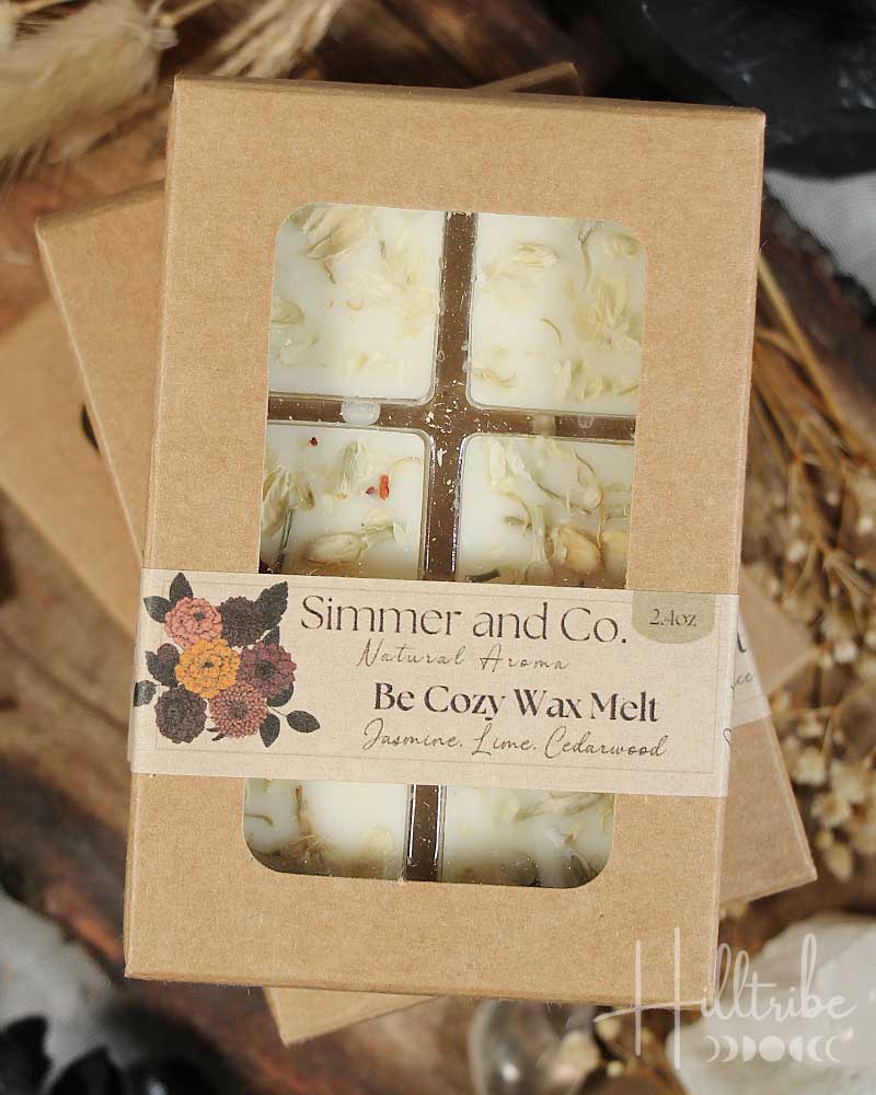 Box of 'Cozy Wax Melt' with dried fruits and herbs on a wooden surface