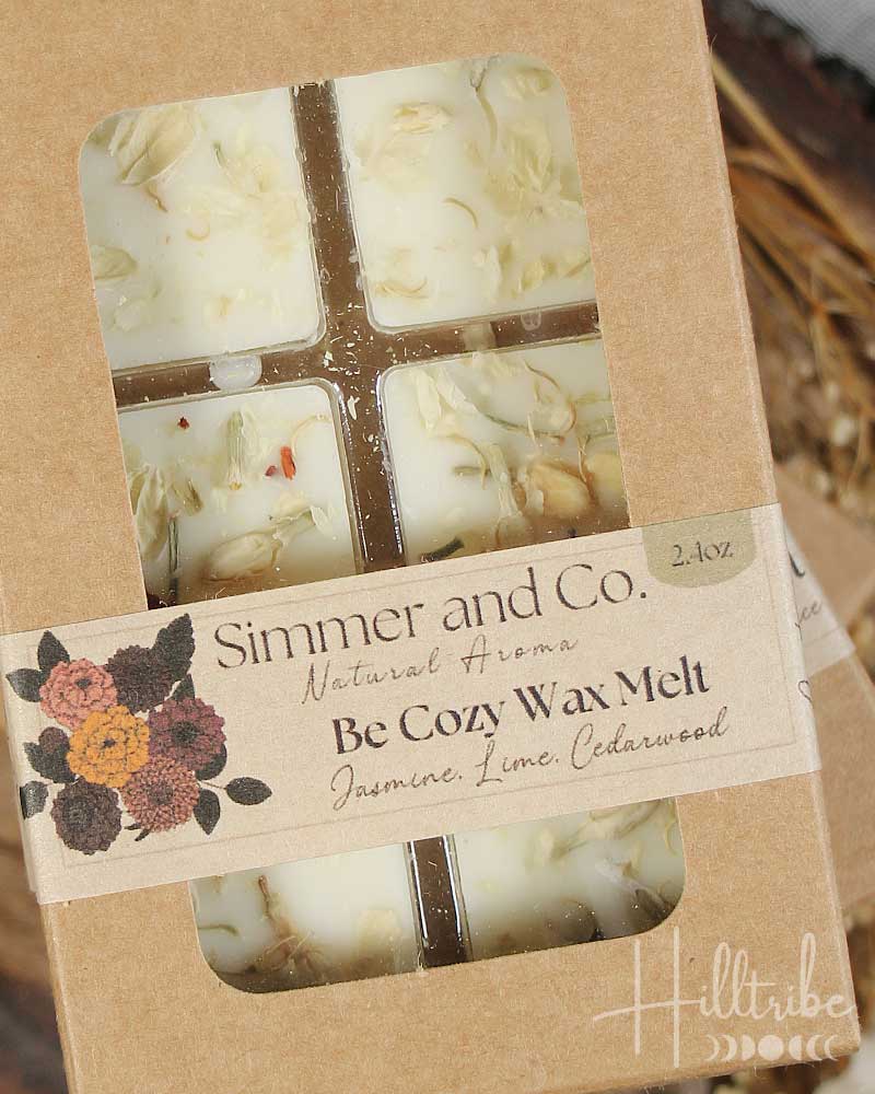 Box of 'Cozy Wax Melt' with dried fruits and herbs on a wooden surface