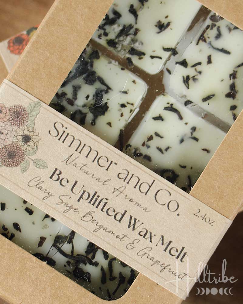 Wax melts in a cardboard packaging with a label on a wooden surface