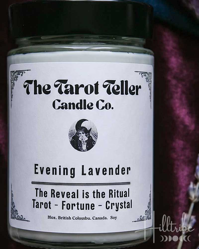 A candle jar labelled 'The Tarot Teller Candle Co.' and 'Evening Lavender' is centred against a dark purple velvet background with lavender sprigs, crystal clusters, stars, and crescent moons.