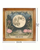 Framed wall art showing a large moon over pink lotus flowers and water, with decorative ornate corners and the text 'THE MOON' at the bottom. The image includes dimension labels indicating 30cm height and 20cm width, under the heading 'PRODUCT DETAILS' on a white background.