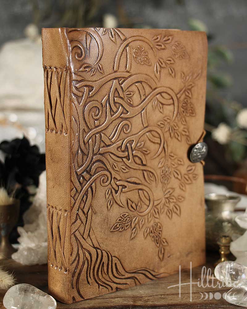 Brown leather journal with embossed design on a blurred background