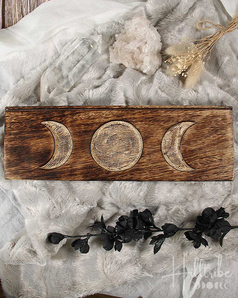 Triple Moon Tarot Card Holder with moon phases on a textured surface with decorative elements.
